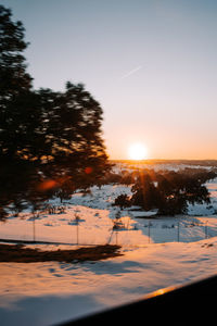 Scenic view of snow against sky during sunset