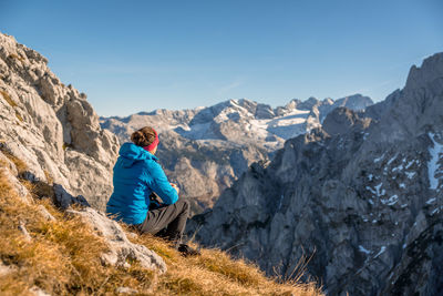 Woman enjoying the view at alpine landscape in autumn, bischofsmütze, annaberg, austria