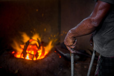 Midsection of man working in fire