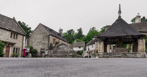 Exterior of houses by buildings against clear sky