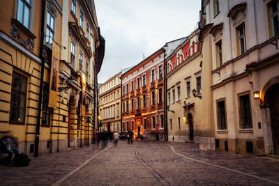 Street amidst buildings in city against sky