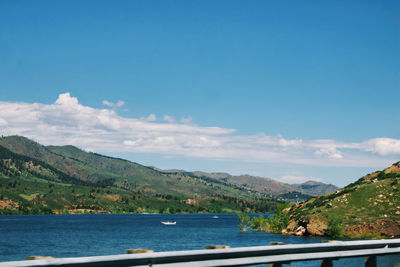 Scenic view of sea and mountains against sky