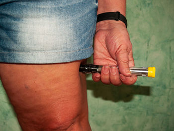 Midsection of woman injecting drug