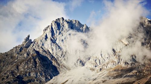 Panoramic view of snowcapped mountains against sky