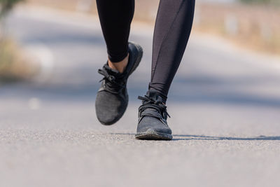 Low section of person walking on street