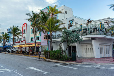 Palm trees by building against sky