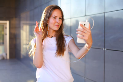 Portrait of young woman using mobile phone