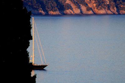 Sailboat in sea against sky