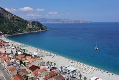 High angle view of sea and buildings against sky