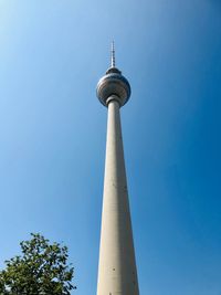 Low angle view of communications tower against sky