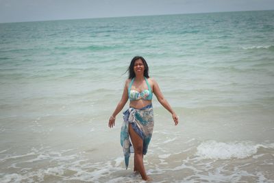 Young woman standing at beach