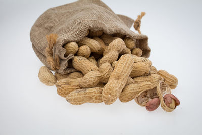 Close-up of dried cake against white background