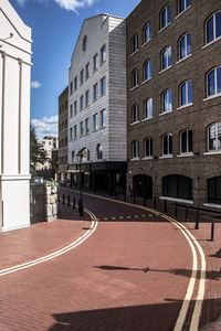 Empty street amidst buildings in city