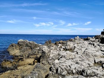 Rocks on beach against sky