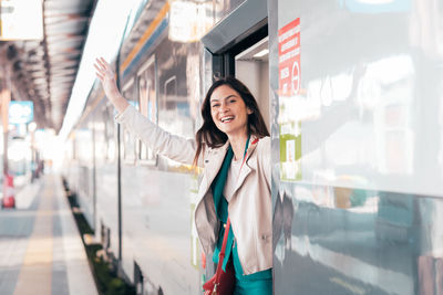 Portrait of young woman standing in city