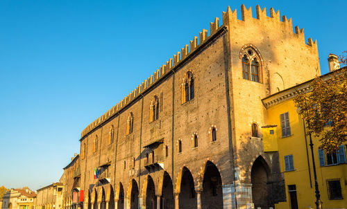 Low angle view of historic building against blue sky