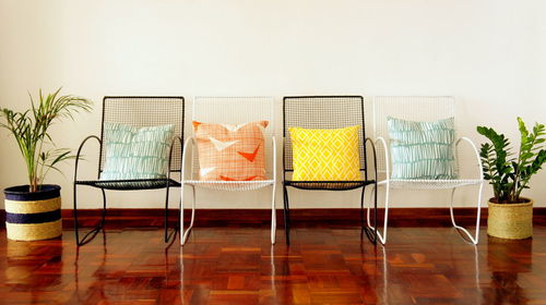 Empty chairs and table against wall at home