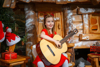 Full length of a girl playing guitar