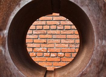 Close-up of brick wall with hole
