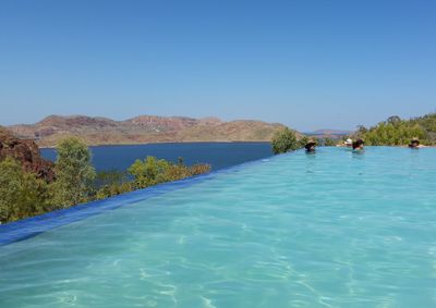 Scenic view of lake against clear blue sky