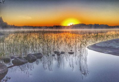 Scenic view of lake at sunset