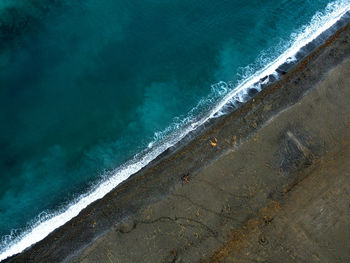 Green sea and brown beach