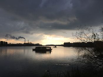 Scenic view of lake against cloudy sky