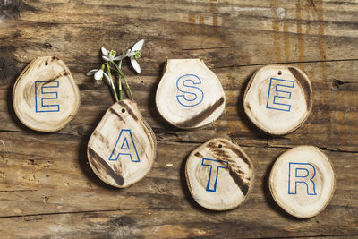 Directly above shot of wood craft and rock on table