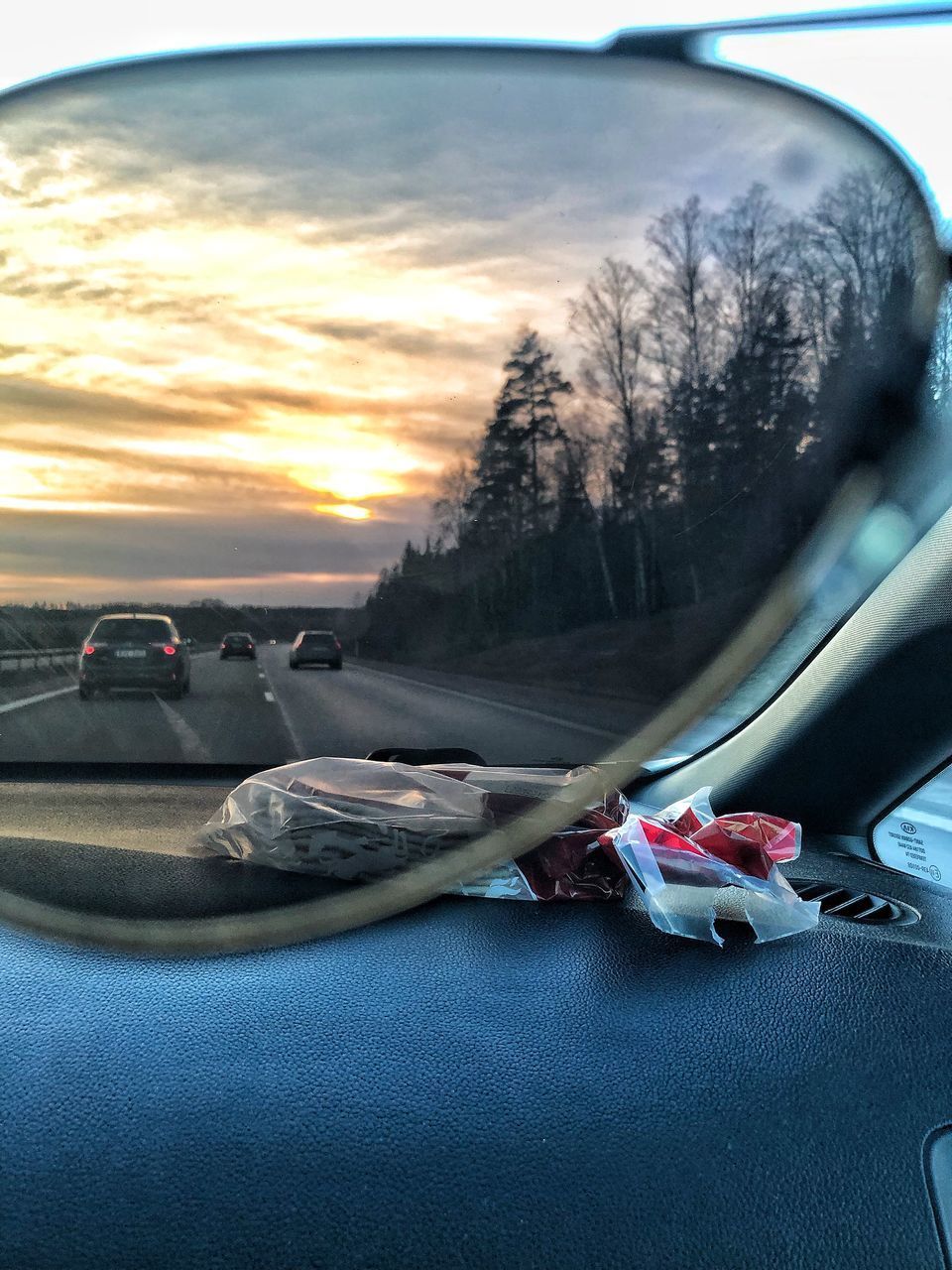 CARS ON ROAD AGAINST SKY DURING SUNSET