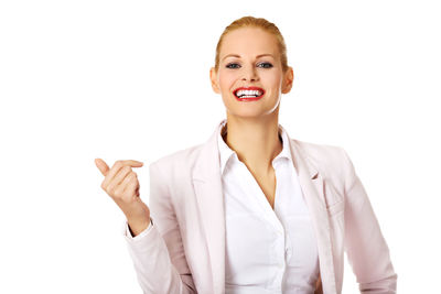Portrait of a smiling young woman against white background