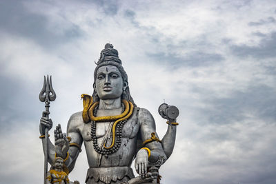 Low angle view of statue against sky