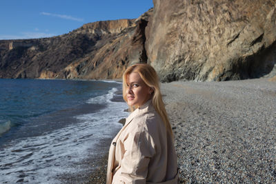 Young woman standing on rock