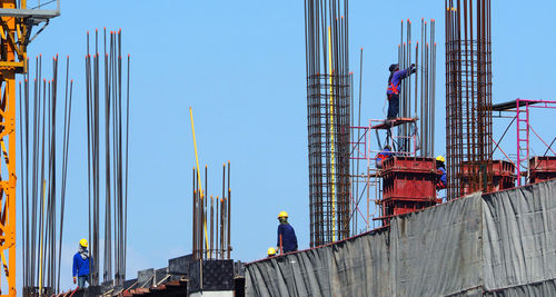 Man working at construction site against clear sky