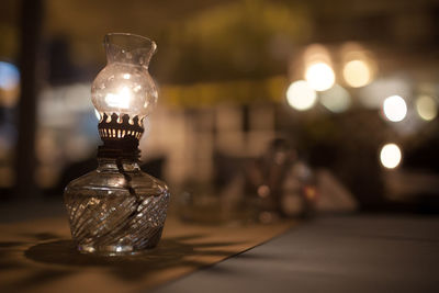 Close-up of antique lamp on table at cafe