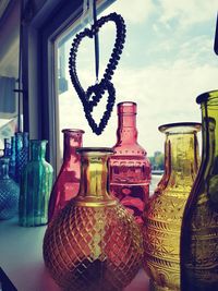 Glass of bottles on table