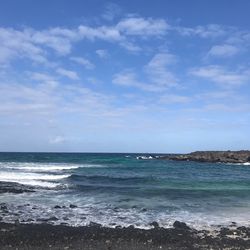 Scenic view of sea against blue sky