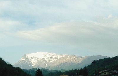 Scenic view of mountains against cloudy sky