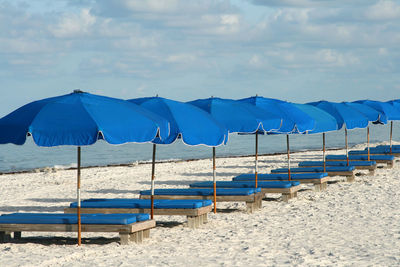 Scenic view of beach against blue sky