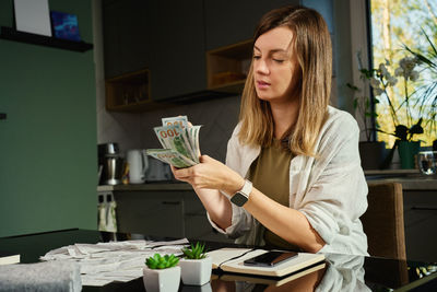Young woman drinking coffee at home