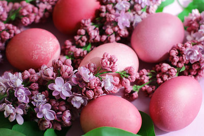 Close-up of beautiful lilac easter eggs with blooming lilac branches. easter decor. selective focus.