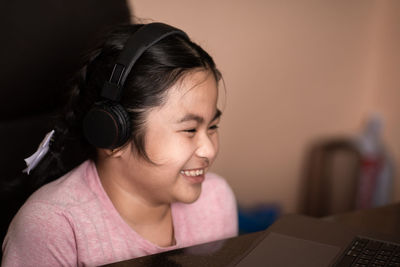 Portrait of smiling girl using mobile phone