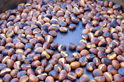 High angle view of roasted chestnuts for sale at market