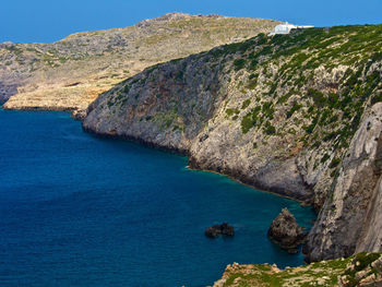 Scenic view of sea with rocks in background