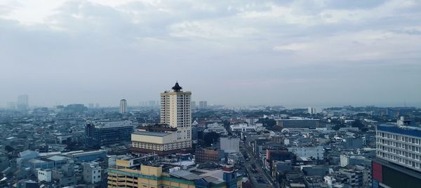 Buildings in city against sky