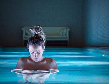 Topless woman in swimming pool