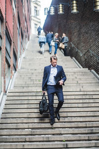 Mature businessman climbing steps