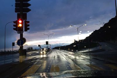 Road passing through illuminated tunnel