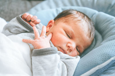 Cute baby lying on bed at home