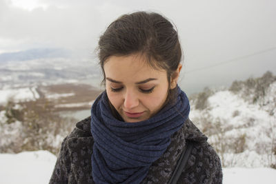 Woman standing on snow covered field