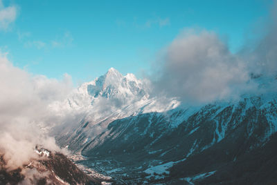Scenic view of mountains against cloudy sky